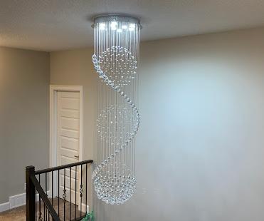Spiral crystal chandelier installed in two-story foyer, Calgary custom lighting project