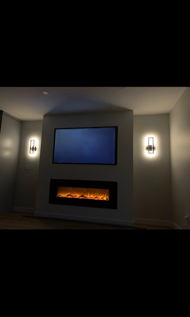 Fireplace feature wall with mounted TV and symmetric wall sconces, Calgary residential project