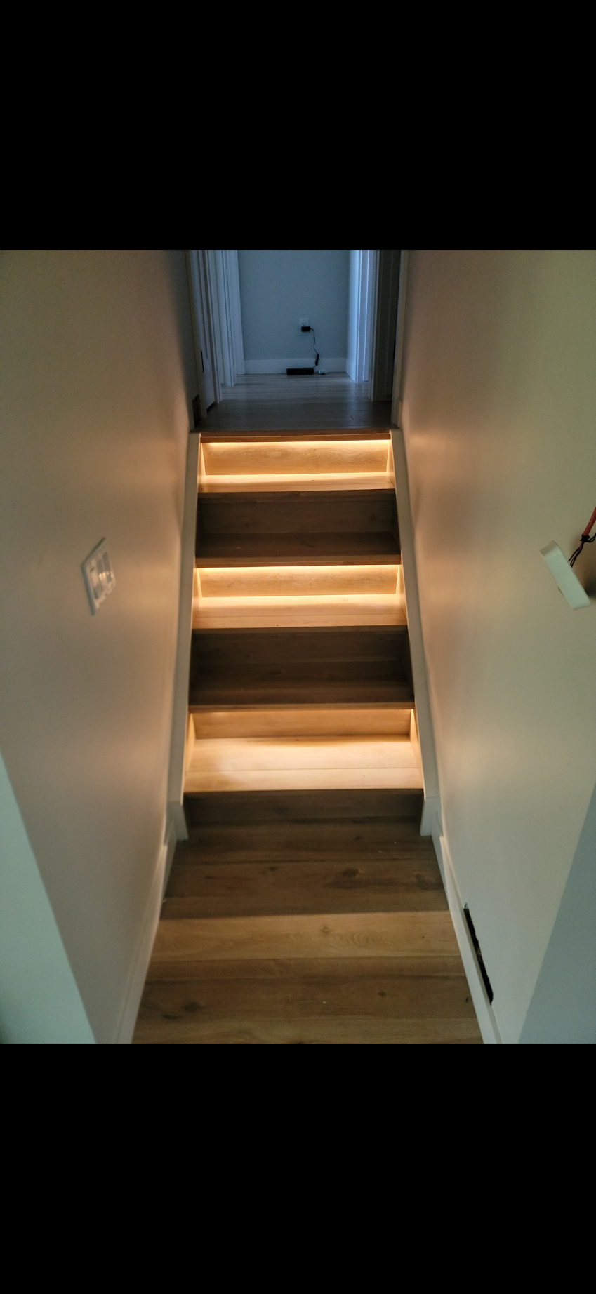 Motion-sensor LED stair lighting installed on residential staircase